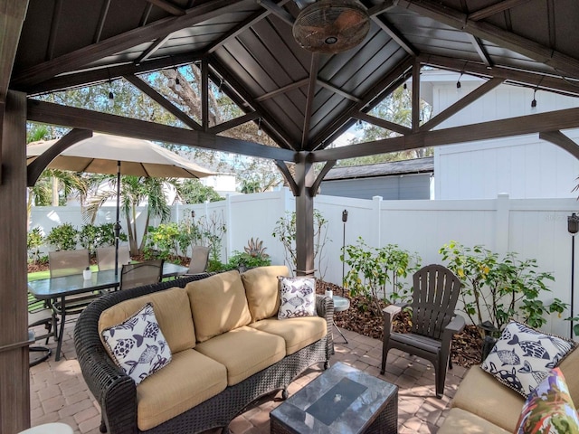view of patio with an outdoor hangout area, a gazebo, outdoor dining area, and a fenced backyard