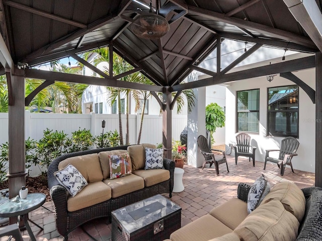view of patio / terrace featuring a gazebo, outdoor lounge area, and fence