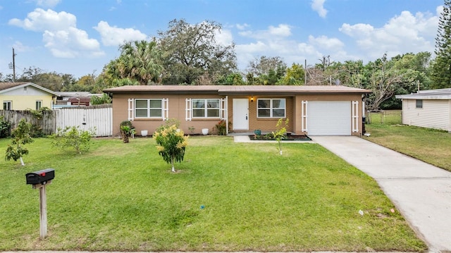 single story home featuring a garage, driveway, a front yard, and fence