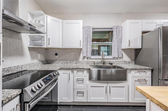 kitchen with stainless steel appliances, white cabinetry, a sink, and open shelves