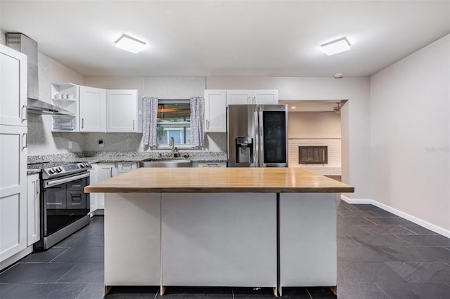 kitchen with a center island, open shelves, stainless steel appliances, white cabinets, and a sink