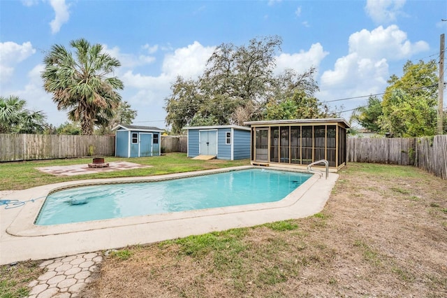 view of swimming pool with an outdoor fire pit, a fenced backyard, a storage shed, an outdoor structure, and a sunroom