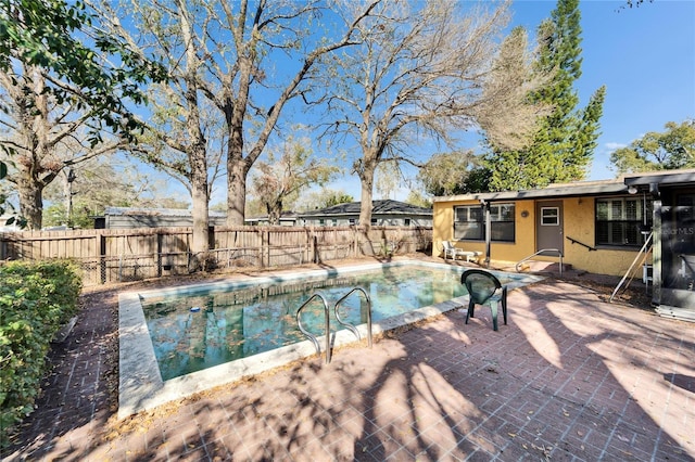 view of swimming pool featuring a patio area, a fenced backyard, and a fenced in pool