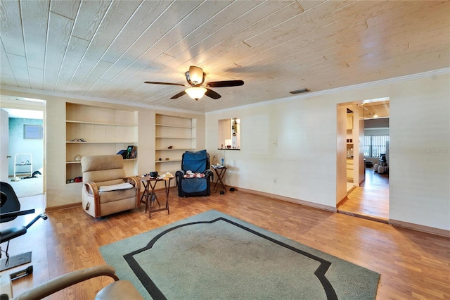 living area with built in shelves, crown molding, visible vents, wood ceiling, and wood finished floors