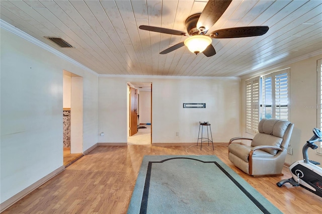 sitting room with wooden ceiling, light wood finished floors, visible vents, and ornamental molding