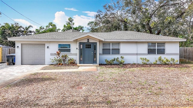 single story home featuring roof with shingles, an attached garage, fence, decorative driveway, and stucco siding