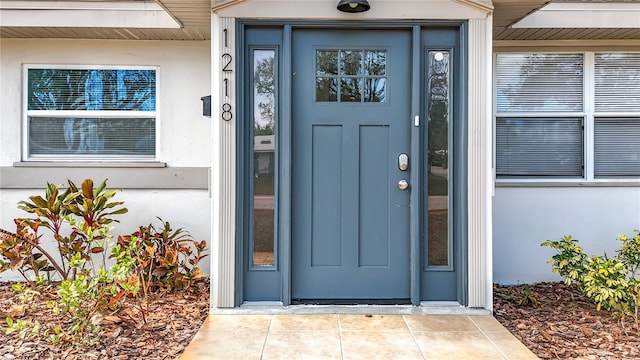 doorway to property with stucco siding