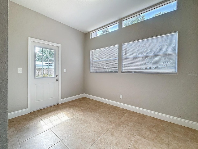 doorway with plenty of natural light and baseboards