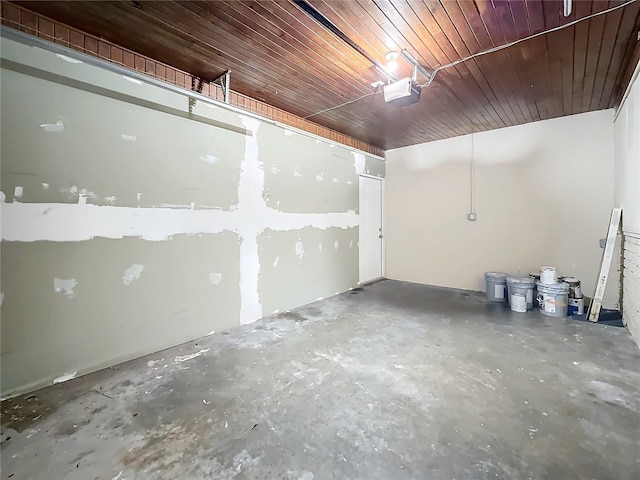 basement featuring a garage and wooden ceiling