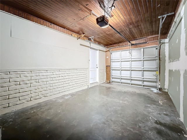 garage with a garage door opener and wooden ceiling