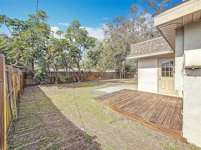 view of yard featuring a fenced backyard and a deck