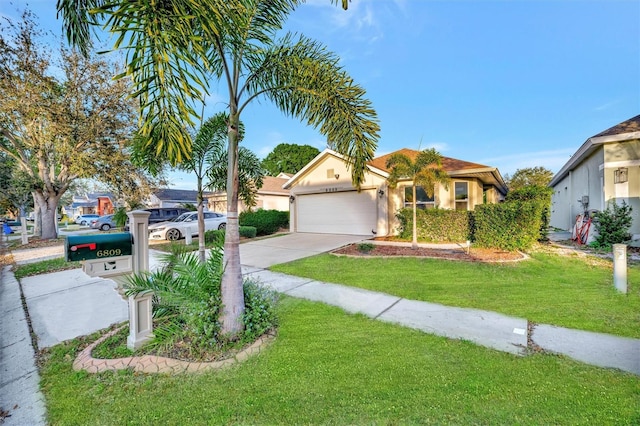 view of front of property with driveway, a front lawn, an attached garage, and stucco siding