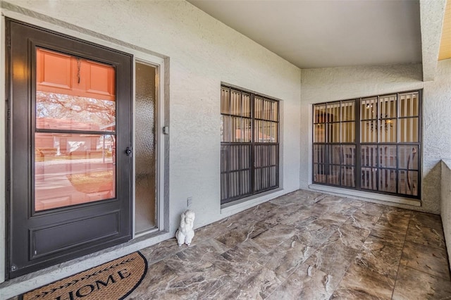 entrance to property with stucco siding