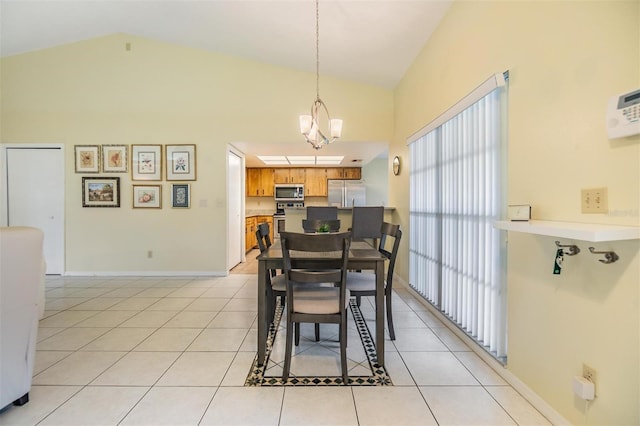 dining area featuring a chandelier, high vaulted ceiling, baseboards, and light tile patterned floors