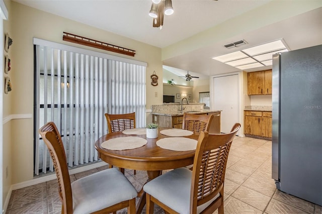 dining area with ceiling fan, light tile patterned flooring, and visible vents