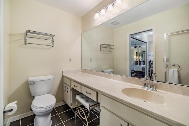 bathroom featuring vanity, connected bathroom, toilet, and tile patterned floors