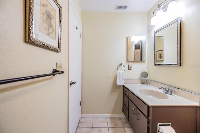 bathroom featuring tile patterned flooring, visible vents, baseboards, and vanity