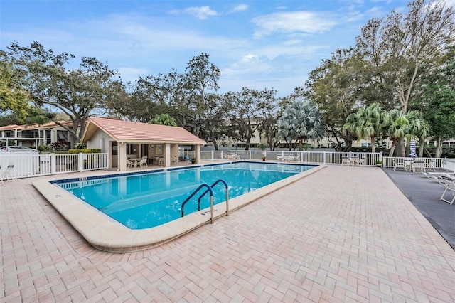 pool featuring a patio and fence