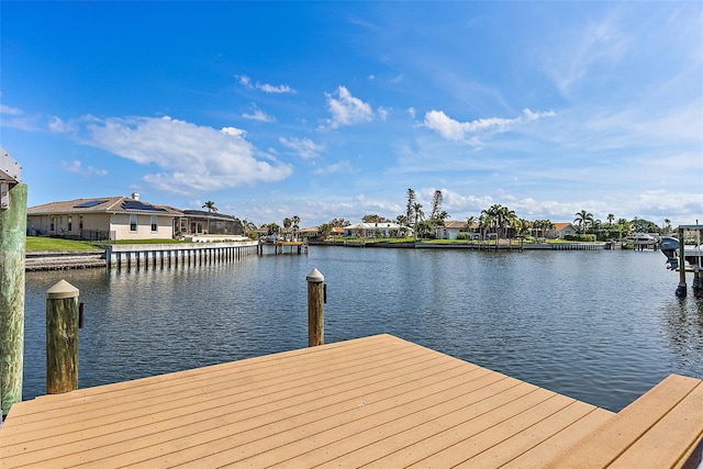 dock area featuring a water view and a residential view