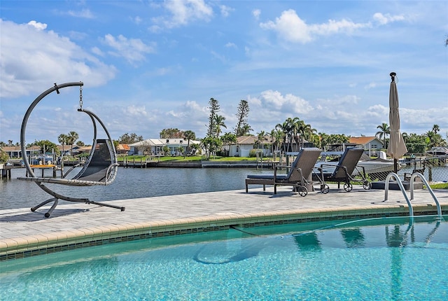 outdoor pool with a water view