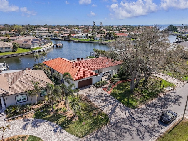 drone / aerial view with a water view and a residential view