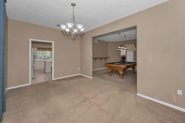 interior space with an inviting chandelier, billiards, baseboards, and a textured ceiling