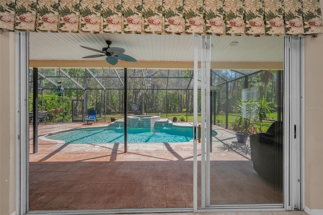 view of swimming pool featuring glass enclosure, a patio area, and a pool with connected hot tub