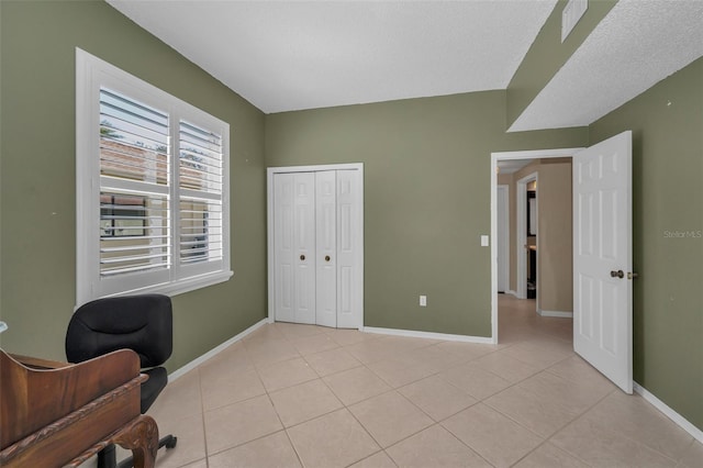 office space with light tile patterned floors and baseboards