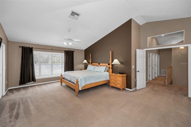 bedroom with carpet floors, ceiling fan, visible vents, and vaulted ceiling