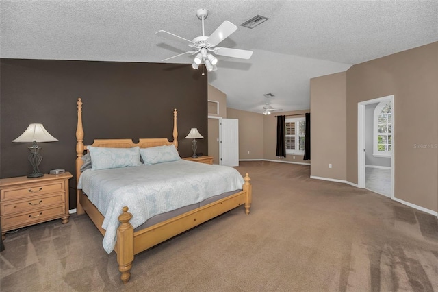 carpeted bedroom with baseboards, visible vents, vaulted ceiling, and a textured ceiling