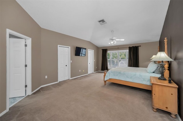 bedroom with lofted ceiling, carpet floors, baseboards, and visible vents