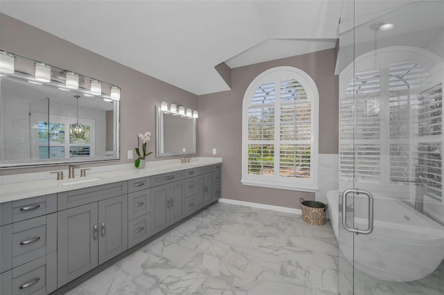 full bathroom with marble finish floor, double vanity, a sink, and a shower stall