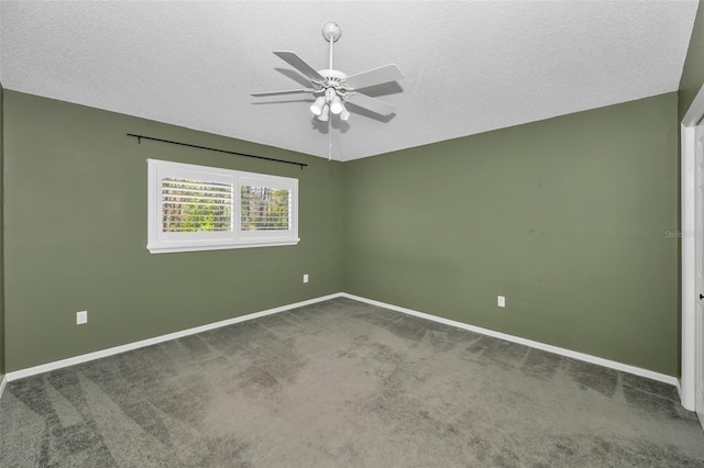 carpeted spare room with a textured ceiling, baseboards, vaulted ceiling, and a ceiling fan