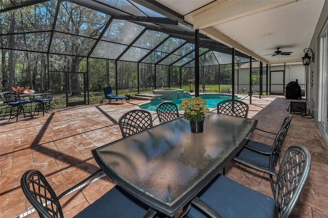 view of patio / terrace featuring a lanai, ceiling fan, a pool with connected hot tub, and outdoor dining space