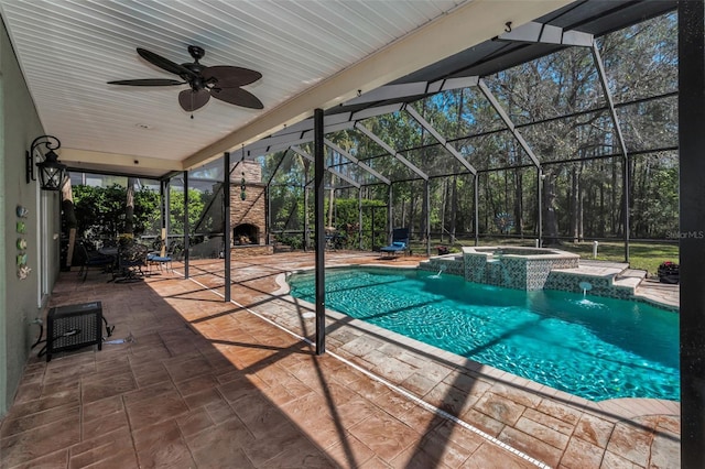 view of swimming pool featuring a lanai, a patio area, a pool with connected hot tub, and a ceiling fan