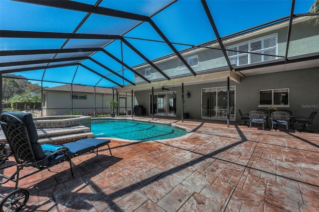 pool with a lanai, a patio, a hot tub, and ceiling fan