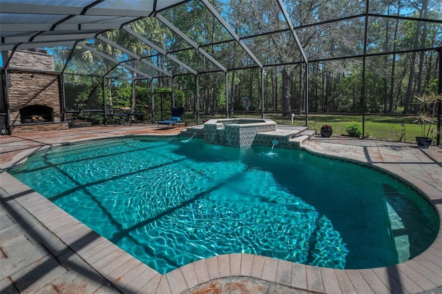 pool featuring an in ground hot tub, an outdoor stone fireplace, a patio, and glass enclosure