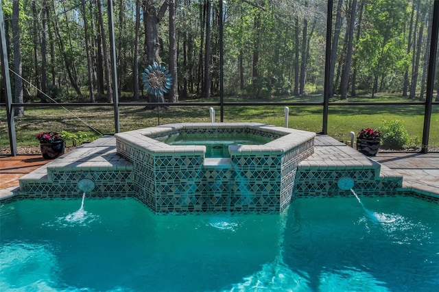 pool featuring a forest view, glass enclosure, a yard, and an in ground hot tub