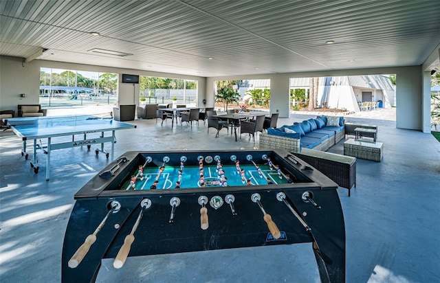 game room featuring finished concrete floors