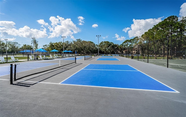 view of sport court featuring fence