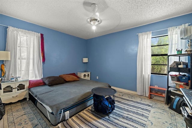 bedroom featuring baseboards and a textured ceiling