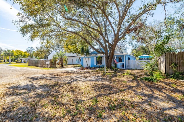 view of front of home featuring fence