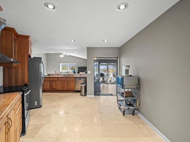 kitchen with baseboards, appliances with stainless steel finishes, brown cabinets, vaulted ceiling, and a sink