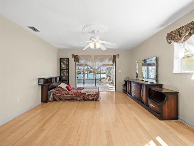 sitting room featuring a wealth of natural light, visible vents, and wood finished floors