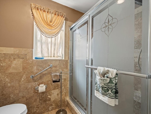 full bathroom with a stall shower and toilet