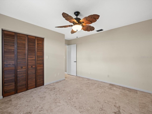 unfurnished bedroom featuring a ceiling fan, visible vents, baseboards, a closet, and carpet