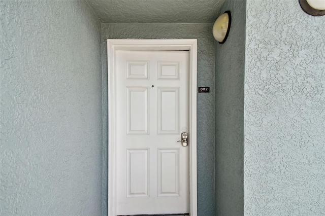 property entrance featuring stucco siding