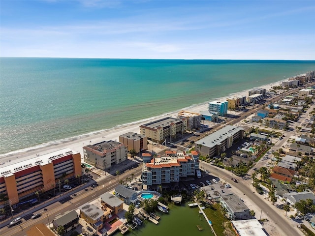 drone / aerial view featuring a view of the beach, a water view, and a city view