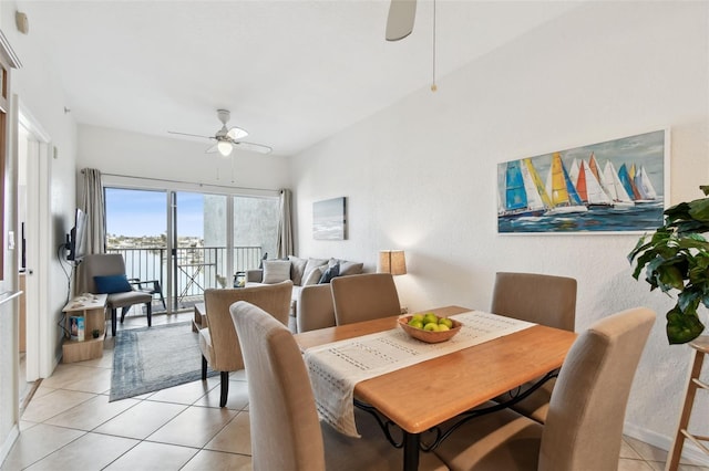 dining space with light tile patterned floors and a ceiling fan