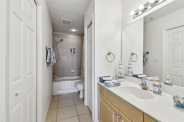 bathroom featuring shower / bath combination with curtain, visible vents, toilet, vanity, and tile patterned floors